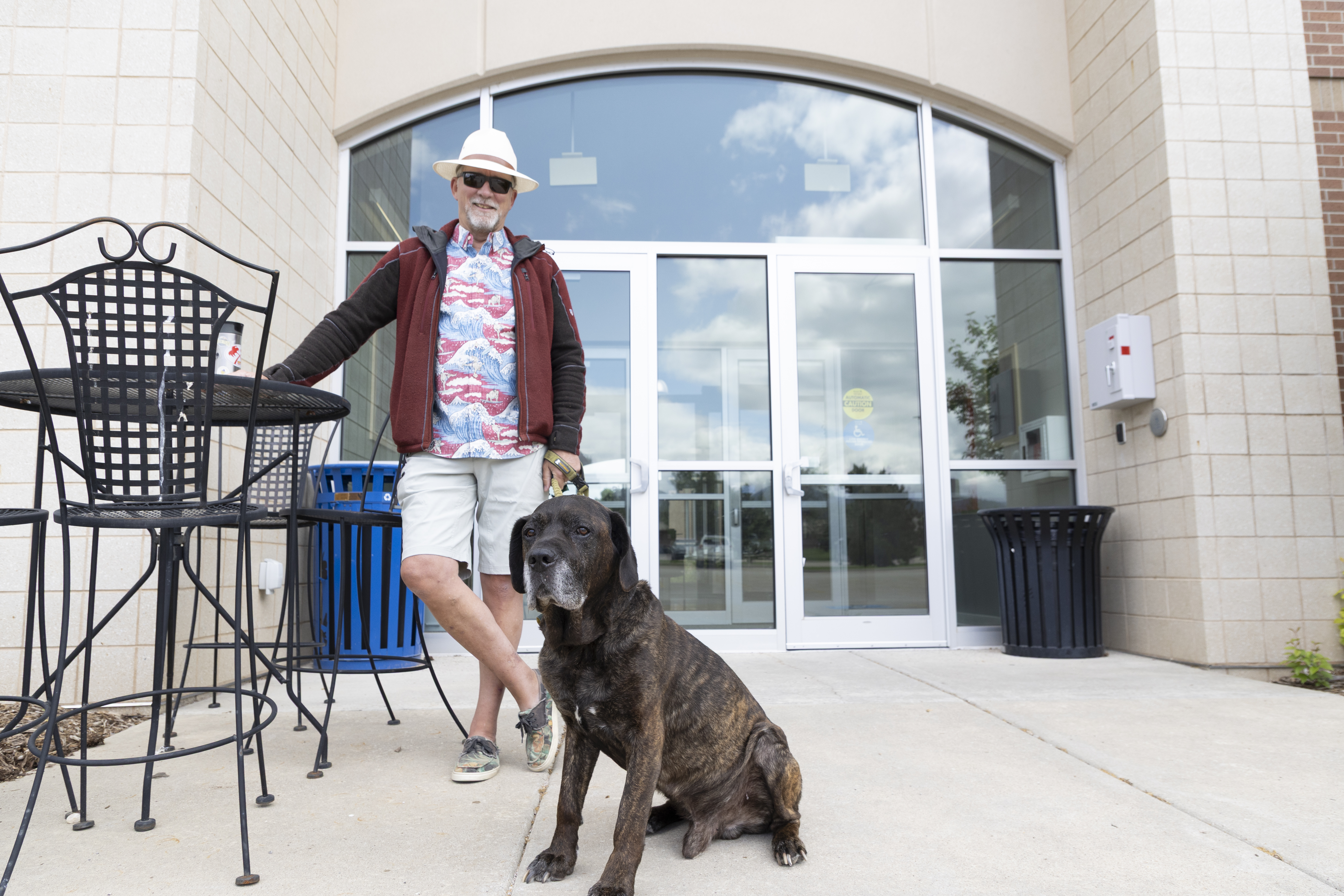 BHSU Professor Charles Lamb stands outside the Life Sciences building on campus with his dog, Bear.