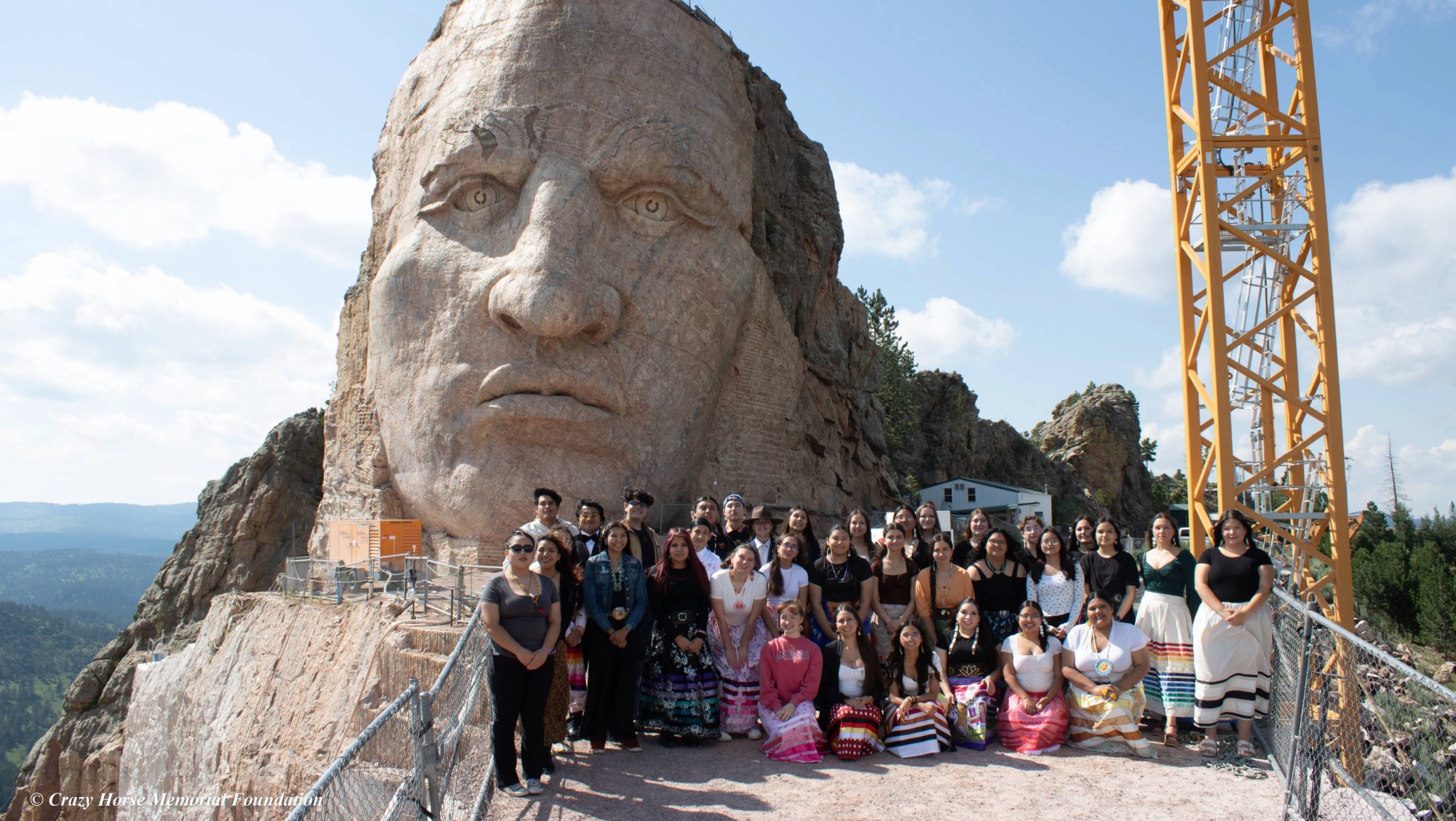 A group of people gather at the top of Crazy Horse Memorial
