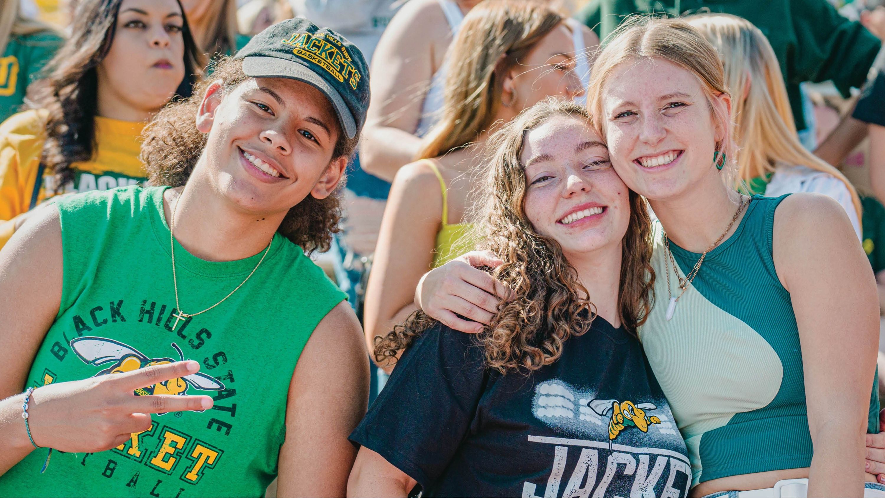 Three BHSU students pose for a photo together at a BHSU football game.